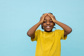 Overjoyed African American little boy sees something surprised