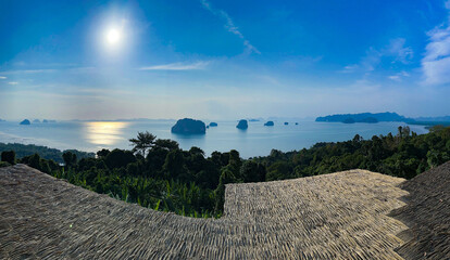 A breathtaking panoramic view of a serene ocean and scattered islands from a tropical hilltop with...