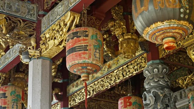 Historic and elaborate hand made Chiense Lanters surrounded by gold leaf beams in the Leong San Tong Khoo Kongsi temple and clanhouse in George Town, Penang, Malaysia
