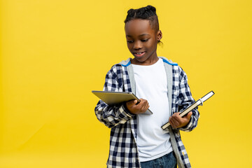 African american boy in checkered shirt with tablet in hands