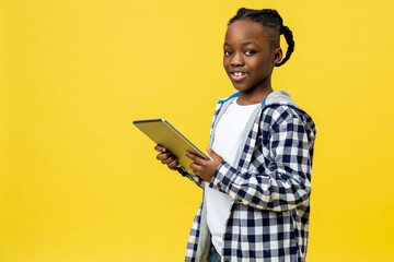 Dark-skinned boy of a school age with tablet in hands