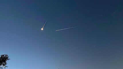Shooting down a rocket in the sky above the calm lake under the starry sky at dusk