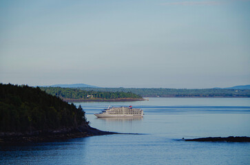 Tiny yacht cruiseship cruise ship liner Constitution anchoring in Bar Harbor, Maine Bay during New...