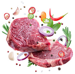 Raw beef steaks, herbs and pieces of vegetables levitating in air on white background. File...