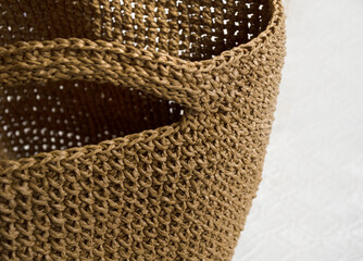 Women's raffia bag close-up. Raffia knitting texture, kraft colors. Crocheted bags, clutches.