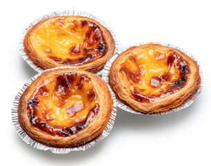 Pastel de nata tarts in foil cups on white background.  File contains clipping path.