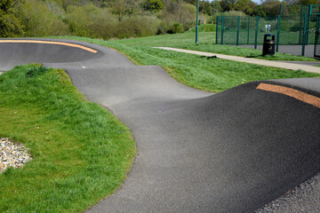 Bike track for riding bmx or mountain bikes with jumps and corners to cycle over on a smooth...