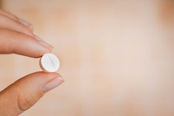 closeup woman hand holding medicine pills

