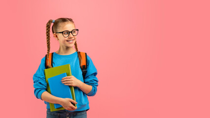 Smiling teen girl with books and backpack