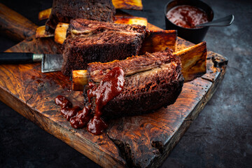Traditional barbecue burnt chuck beef ribs marinated with spicy rub and served as close-up on an...