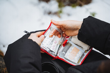 Take pills out of the first aid kit, a small first aid kit, camping equipment, emergency care in...
