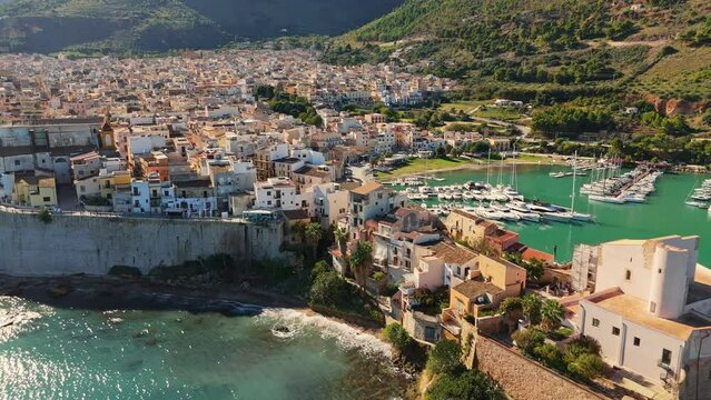Flying over old town embankment in Castellammare del Golfo, Sicily, Italy. In the past one of the two main mafia centers in Sicily