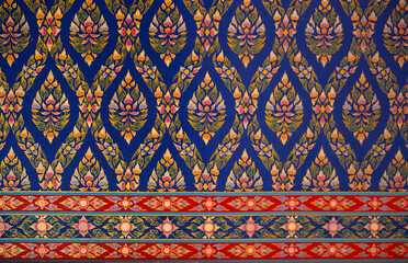 Thai style art ornament seamless pattern wallpaper, depict flower background, Red,blue,green and yellow design on the wall at temple in Thailand.