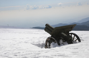 old cannon from the First World War in northern Italy with lots of white snow in winter