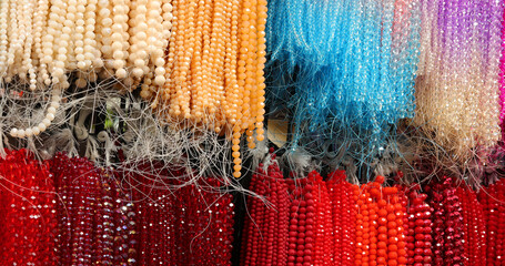 necklaces made of colored glass paste and strung on nylon thread in the shop