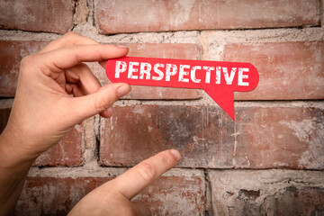 Perspective. Red speech bubble with text on a red brick background - 792001634