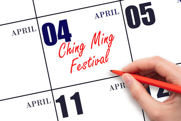 April 4. Hand writing text Ching Ming Festival on calendar date. Save the date.