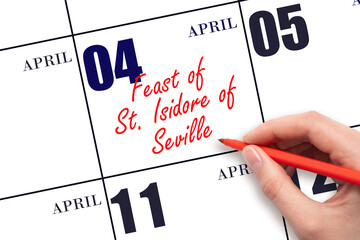 April 4. Hand writing text Feast of St. Isidore of Seville on calendar date. Save the date.