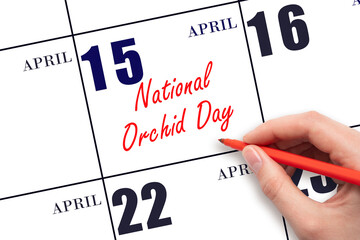 April 15. Hand writing text National Orchid Day on calendar date. Save the date.