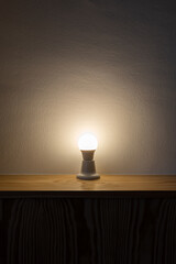 A Light Bulb On A Wooden Table