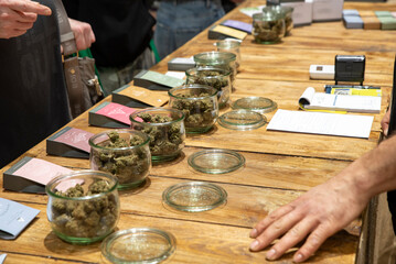 Bologna, Italy - 2024, April 14: Jars full of dried cannabis flowering tops. Best quality selection.