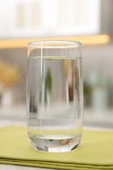 Glass with clear water on table in kitchen