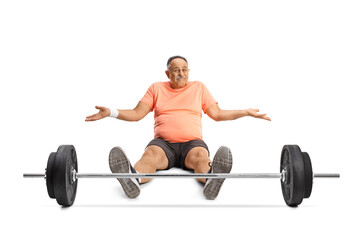 Fototapeta na wymiar Mature man in sportswear sitting on the ground with a barbell