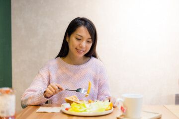 Woman enjoy her meal at coffee shop