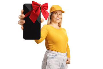 Young female holding a new smartphone with a red bow and pointing