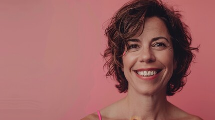 Place for text. Brunette woman smiling joyfully on pink background