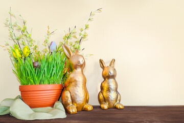 blooming potted spring flowers standing, front view of decorative Easter rabbits
