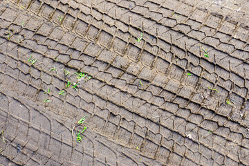 Car tire tread pattern prints in the mud, wheel protector marks texture, tyre tracks in the mud