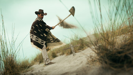 Man digs a grave in the desert