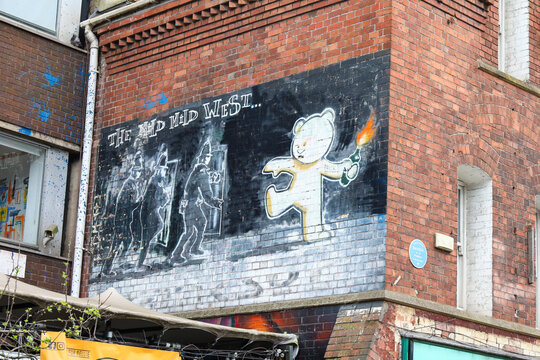 Banksy graffiti called 'Mild Mild West' on facade in Stokes Croft neighborhood in Bristol city