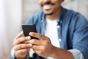 Obraz na płótnie Canvas Man browsing on smartphone with focus on screen