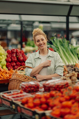 Happy customer standing at farmers market with basket and smiling.
