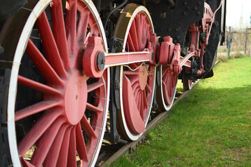 Wheels of an old steam locomotive standing on the tracks