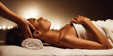 Woman enjoying face massage and aroma therapy in spa