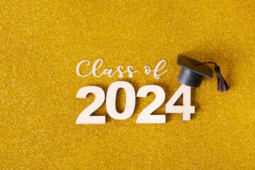 Class of 2024 text. Golden glitter background with number 2024 and graduated cap