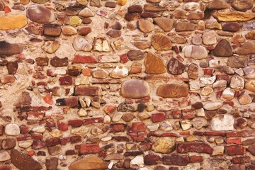 House made of stones in Italy . Background of stone wall texture. Close up of stone wall texture.