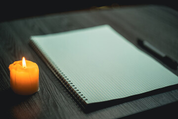 Large notebook and black marker in candlelight