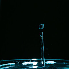 Water drop closeups while drops falling down and splashing into water in Jena