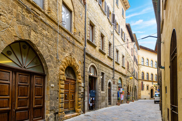 A picturesque narrow alley in the historic medieval old town of the walled hilltop city of Volterra, Italy, in the Tuscany region.