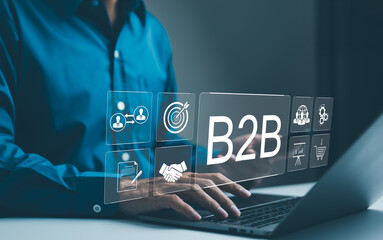 B2B business strategy concept. Businessman working with a B2B virtual interface on a laptop, conceptualizing strategy, partnership, targets in business to business services. E-commerce, B2B Marketing