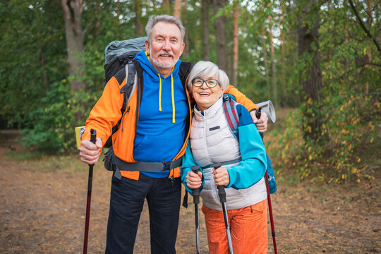 Hiking tourism adventure. Senior couple man woman enjoying outdoor recreation hiking in forest. Happy old people backpackers hikers enjoy walking hike trekking tourism active vacation beauty of nature
