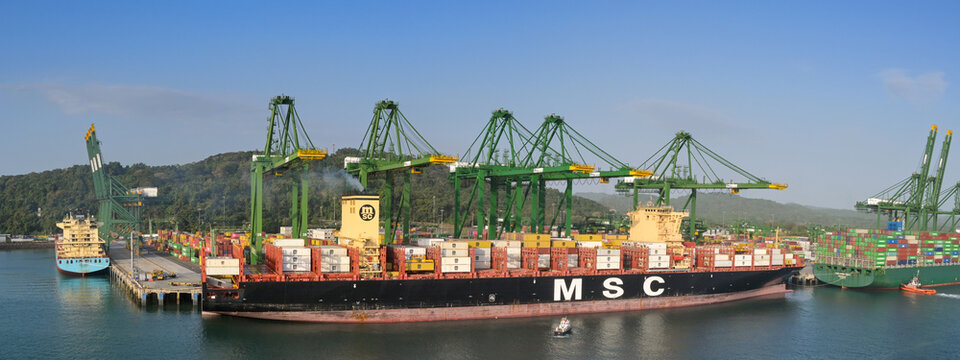 Panama City, Panama - 23 January 2024: Panoramic view of cranes unloading the container ship MSC Cassandre docked in the port of Panama City