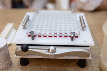 Capsule machine at the pharmacy pharmacist  making medicine pills treatment red capsules remedy
