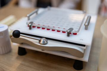 Capsule machine at the pharmacy pharmacist  making medicine pills treatment red capsules remedy