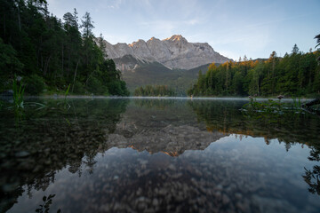 Lake eibsee at dawn with still water reflection
