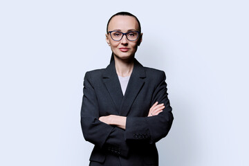 Portrait of business woman with crossed arms, on white studio background